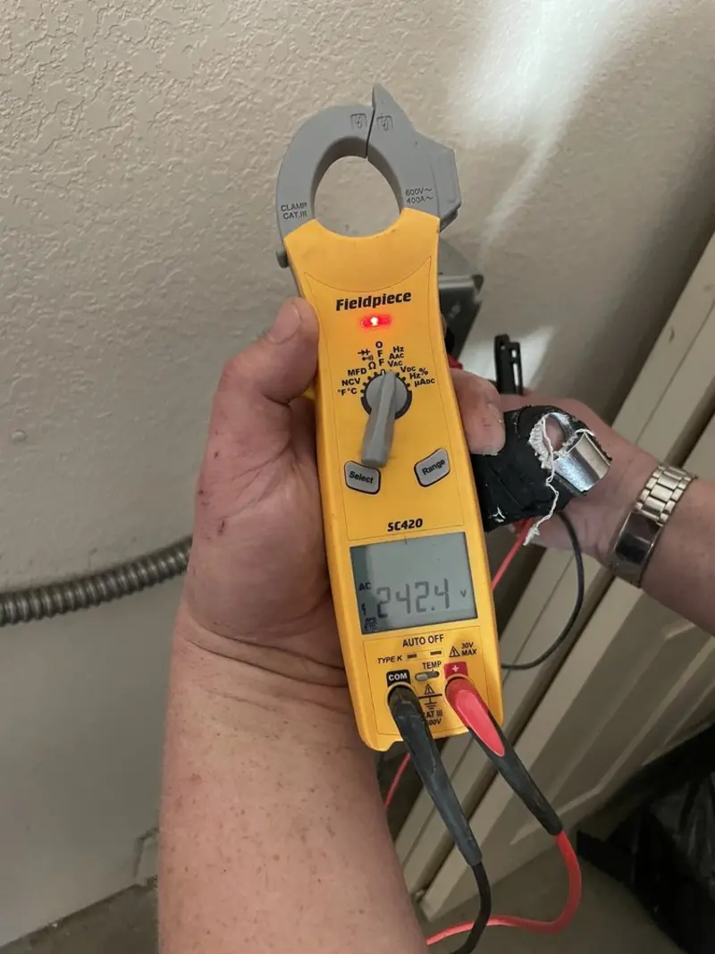 Voltage testing with clamp meter during Ceiling Fan Installation in Candler-McAfee